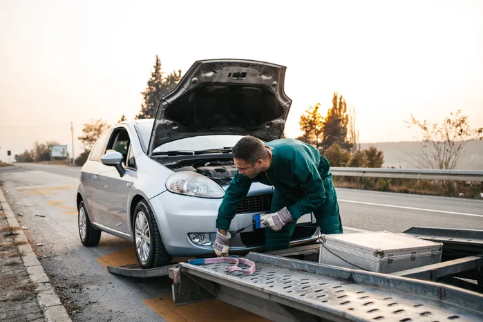 car being lifted on to a tow truck after a car accident