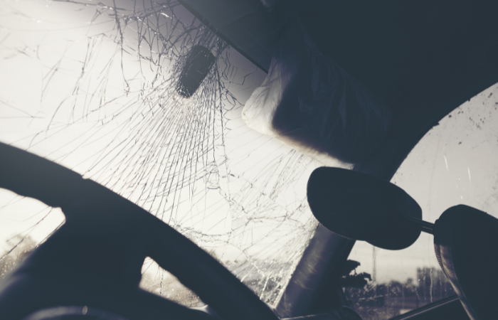 Image of a car with a broken windshield due to a car wreck