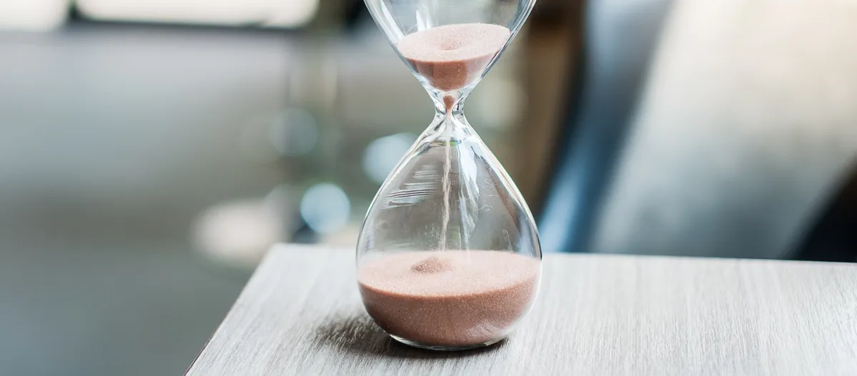 hourglass on a table to repersent time passing