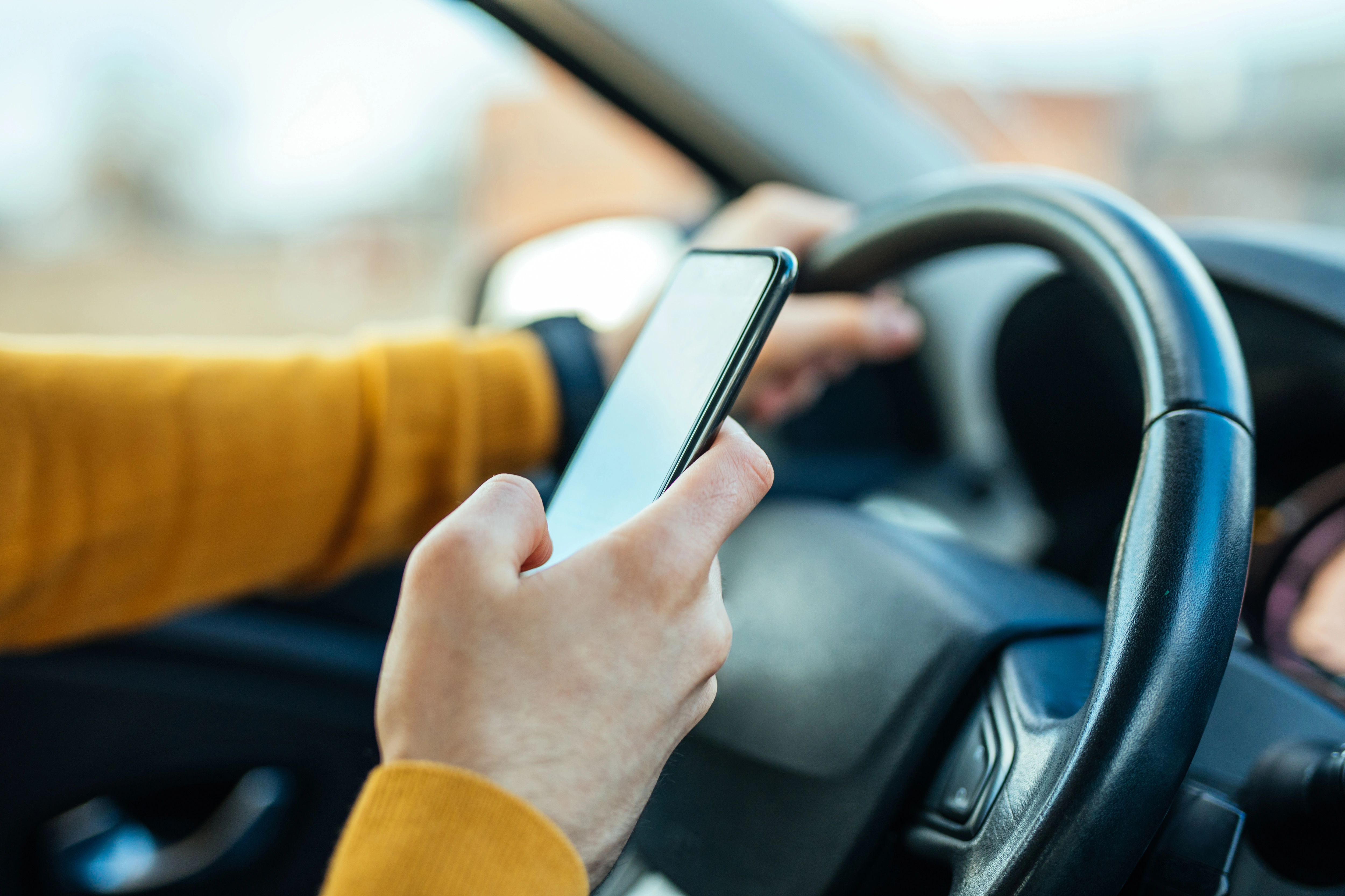 Image of a driver on their phone 