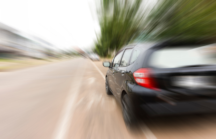 Image of a speeding black sedan