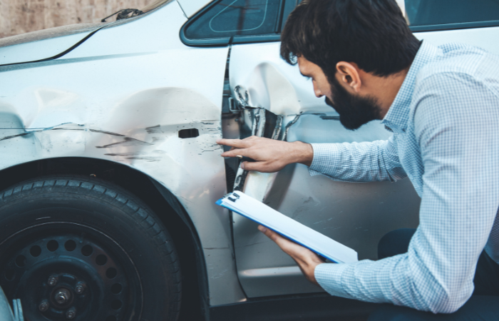 Man analyzing a car after a car accident