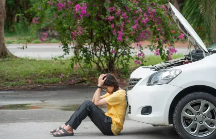 Image of a woman sad after her car broke down