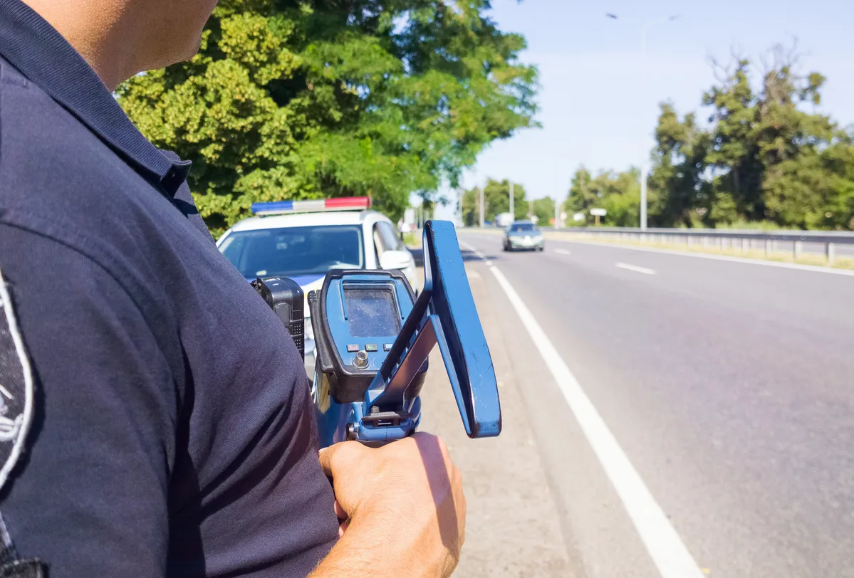 policeman holding a speed gun