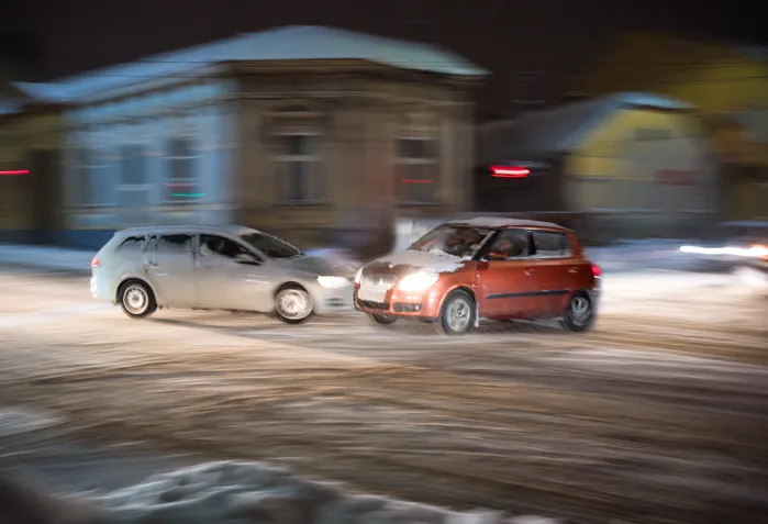 two cars colliding in snowy weather