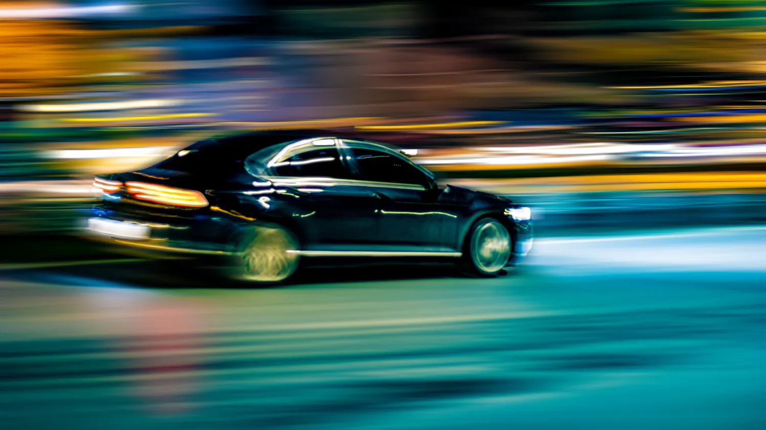 Image of a black car speeding on the road