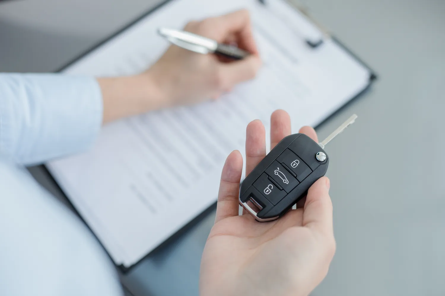 Women signing a car lease agreement