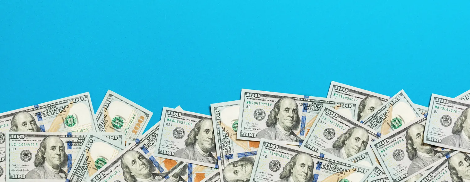 Image of money in front of a blue background