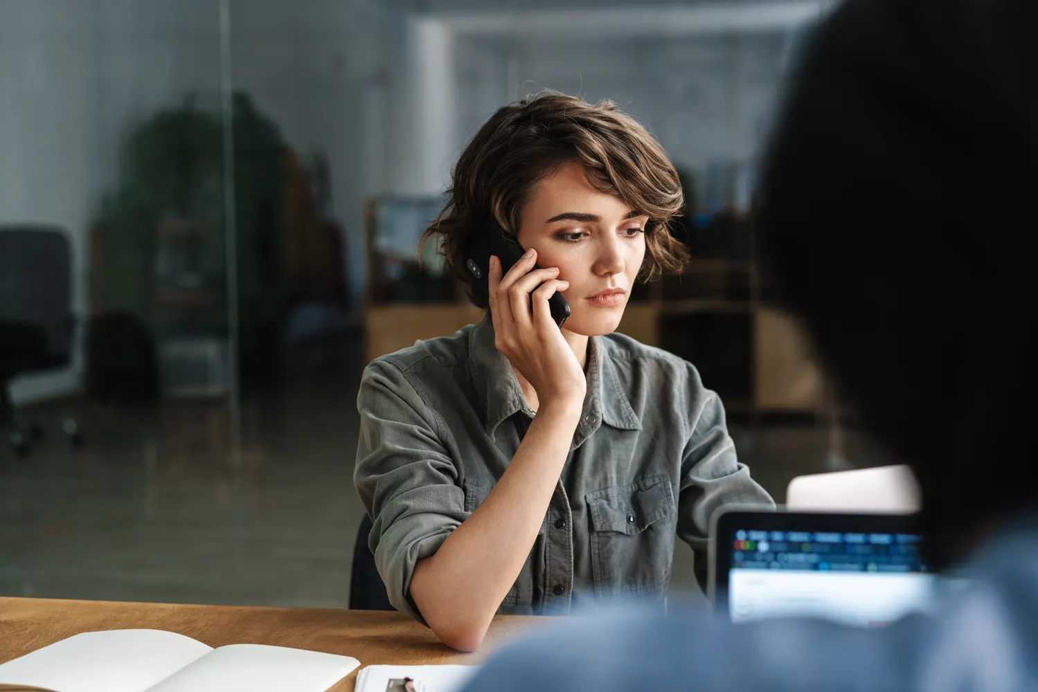 Image of a woman talking on the phone with an insurance adjuster.