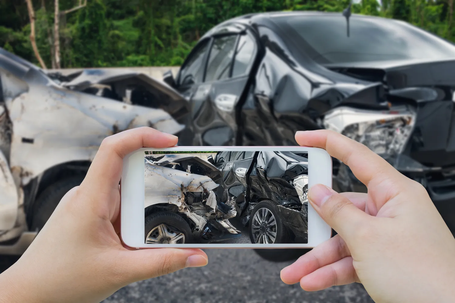 A person taking a photograph of a t-bone car accident