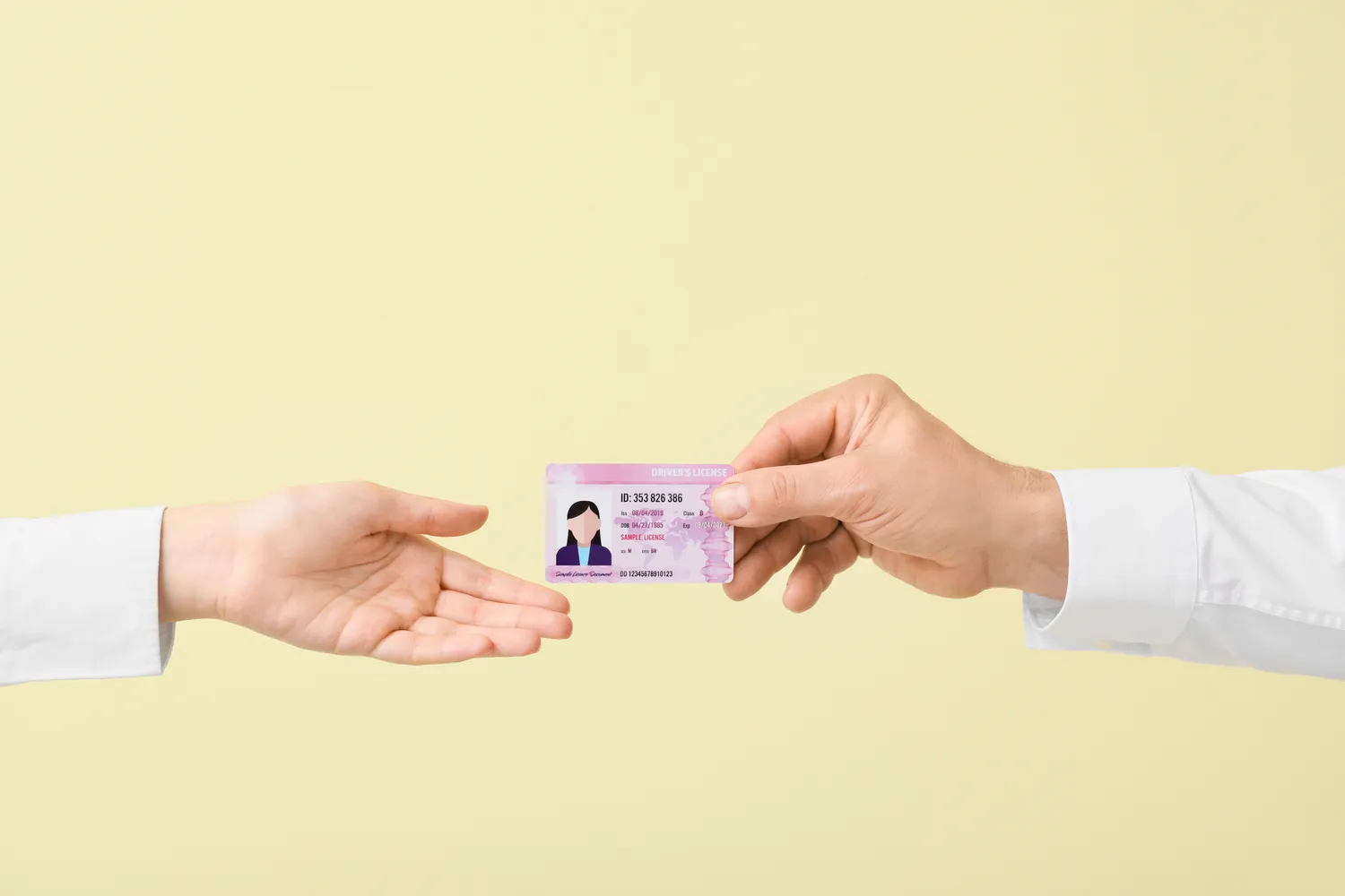 A person handing another a driver's license