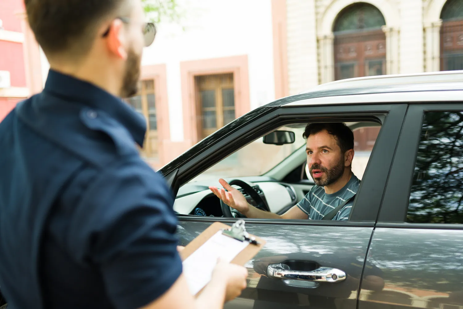 Man receiving a fine from a police officer